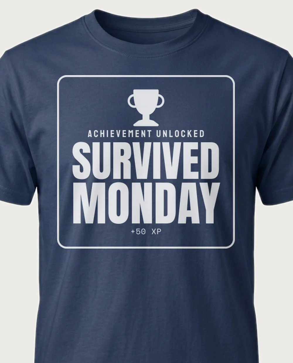 'Survived Monday' — Achievement Unlocked on a navy tee