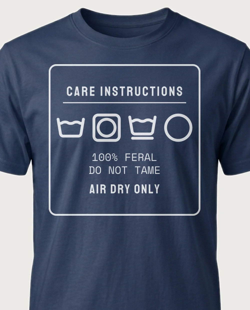 '100% FERAL' — Care Label on a navy tee