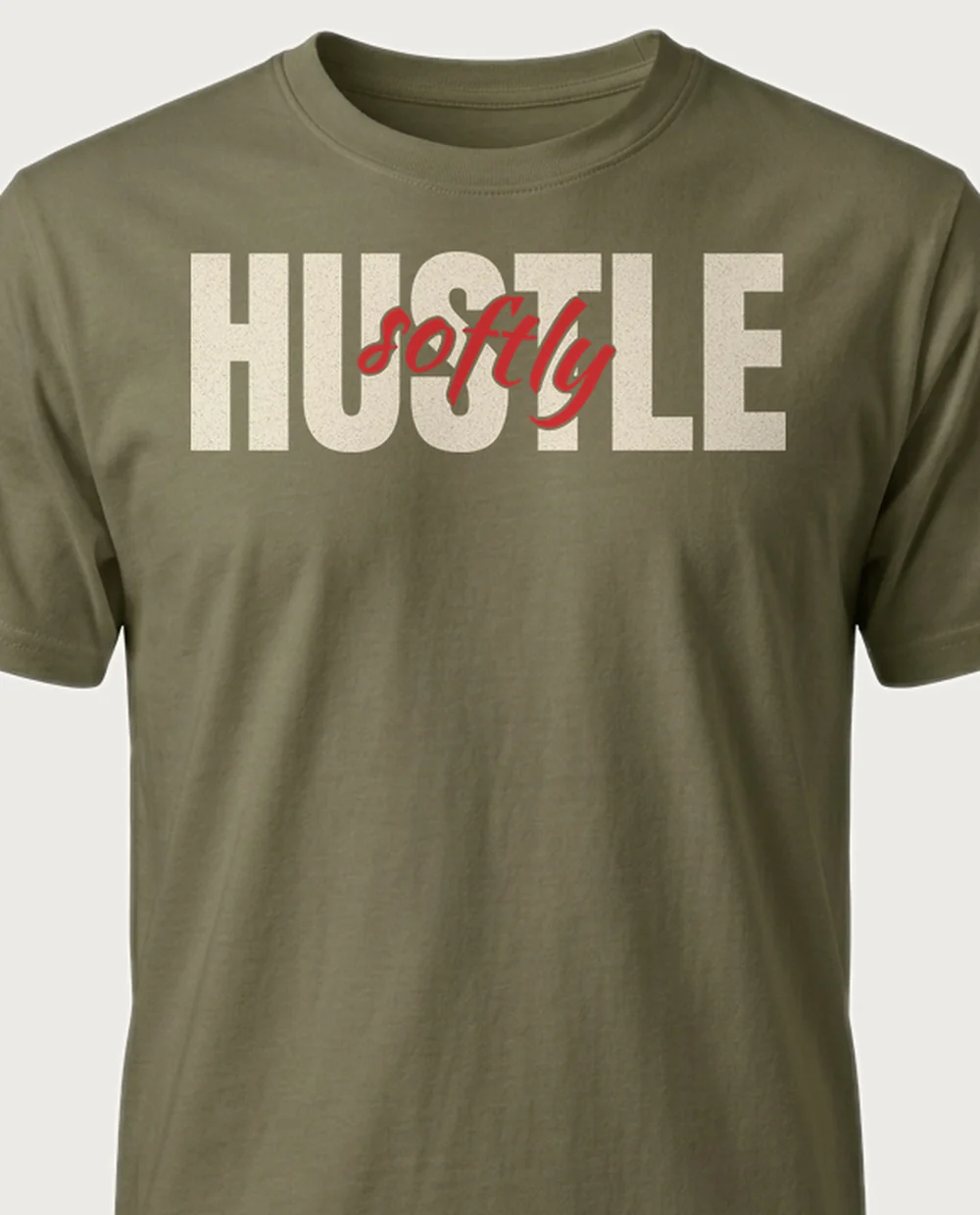 hustle SOFTLY — Script Overlay on a military green tee